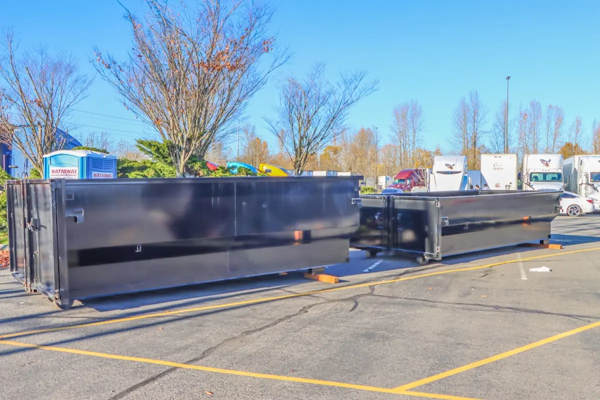 Professional dumpster rental service with roll-off container on residential driveway in Kingsbury